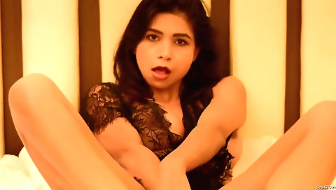 Brunette with long hair and a sexy body is alone on the couch