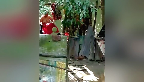 Indian chick is bathing in the sunshine and stripping naked