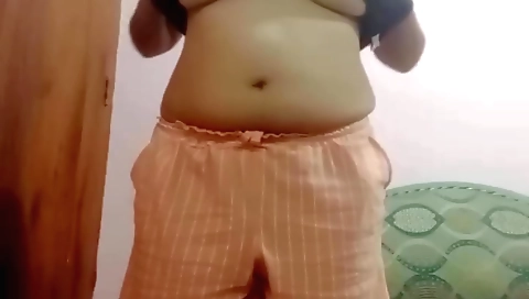 Brunette beauty in a red dress masturbates in the webcam