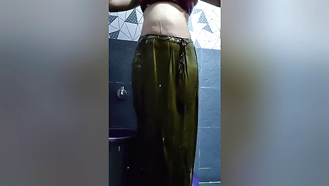 Indian girl in the bathing room has her body in the water