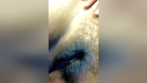 Girl with a hairy pussy slides a dildo down in her cunt