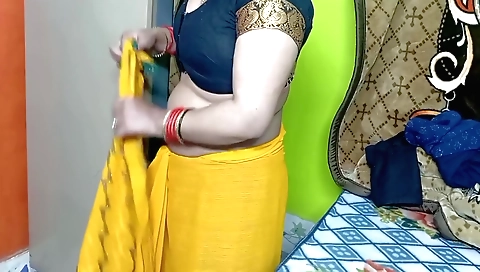 Indian chick in a yellow color sari in the bedroom